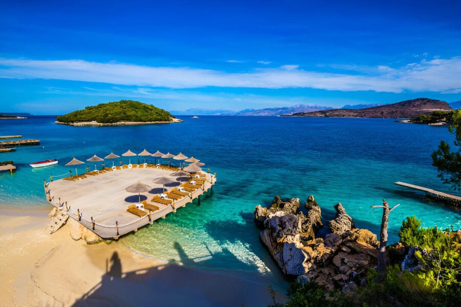 Plaża w Ksamil, położona w południowej Albanii, jest znana z białego piasku i krystalicznie czystej wody, a jej urok podkreślają malowniczo położone na morzu małe wyspy, do których można dopłynąć pływając.
